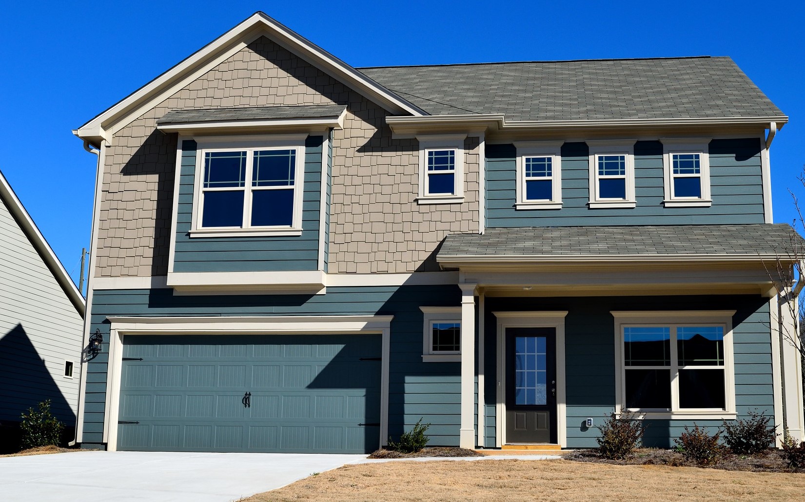 House with blue Garage Doors in OKC, Oklahoma City, Mustang, OK, El Reno City, and Nearby Cities